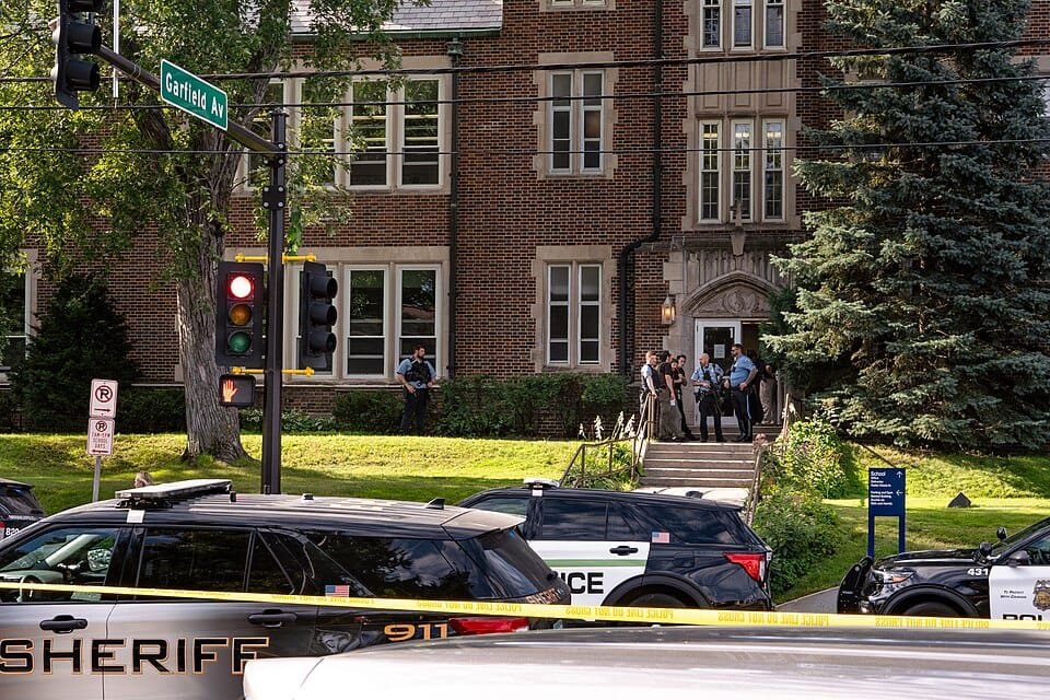 Police at Annunciation Catholic School in Minneapolis on August 27, 2025 following a mass shooting that killed 2 children and injured 17 others, 14 of them children.